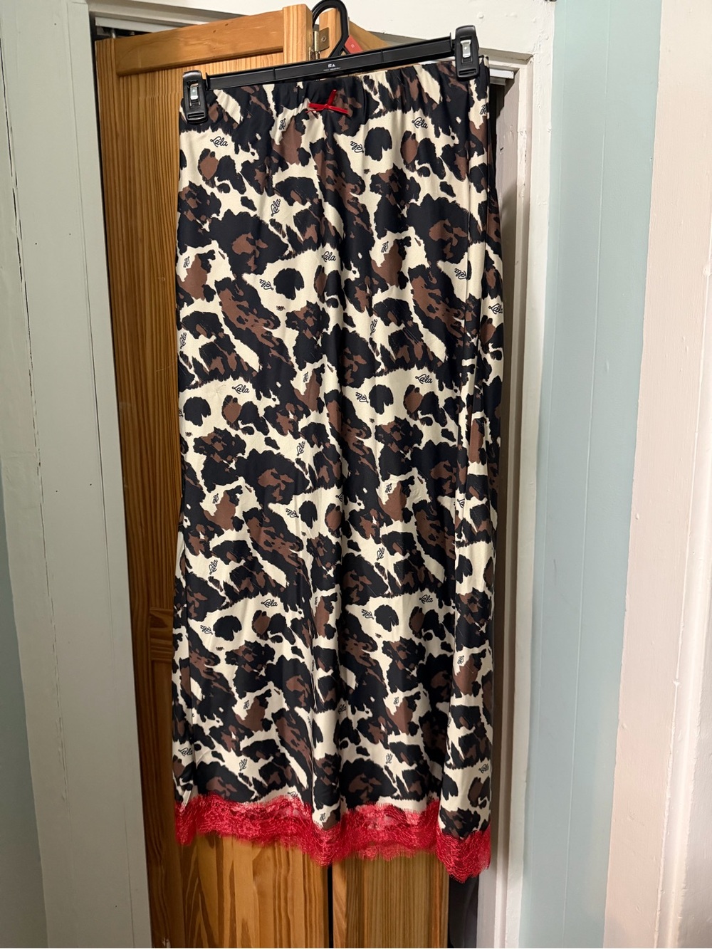 Dressed in LALA Leopard Print Satin Maxi Skirt with Red Lace Hem